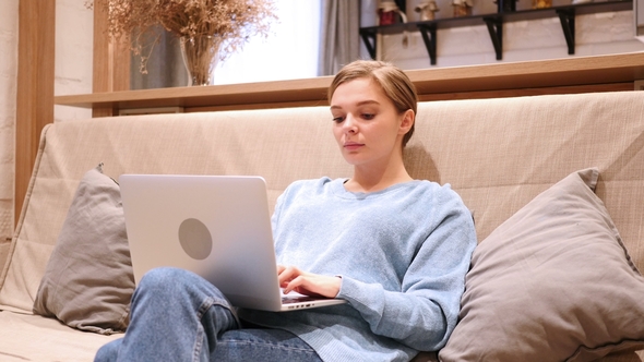 Woman Typing Email on Laptop, Sitting on Couch