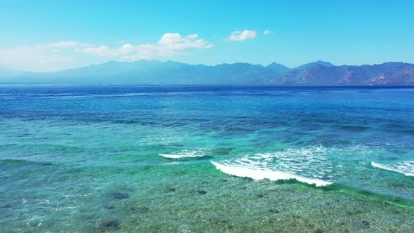 Aerial view panorama of tranquil seashore beach vacation by shallow sea and white sandy background o