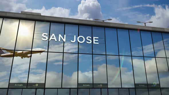 Airplane landing at San Jose California, Costa Rica airport mirrored in terminal