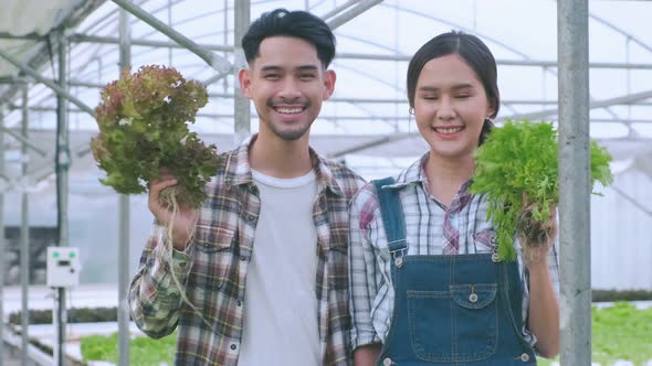 handheld asian couple farmer takecare and discuss how to growth plant in farm