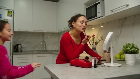 Loving Mother Fooling with Daughter While Applying Makeup at Home