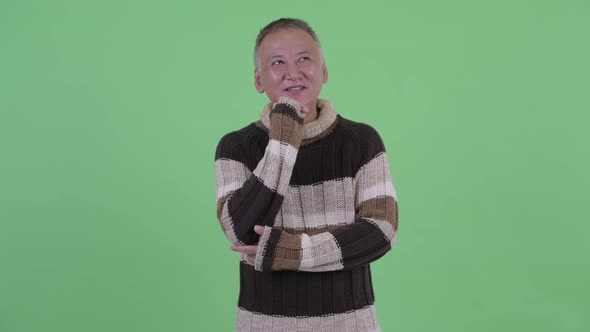 Happy Mature Japanese Man Thinking Ready for Winter