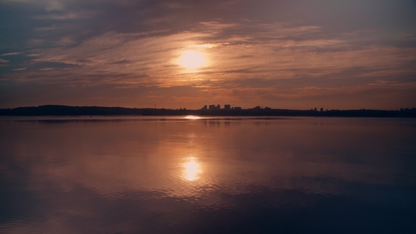 Skyline Between Waterscape and Setting Sun