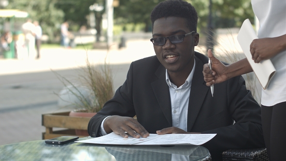 Afro American Business Man Ordering in Outside Cafe