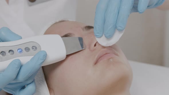 Cleaning the face with ultrasound. The concept of health and beauty.