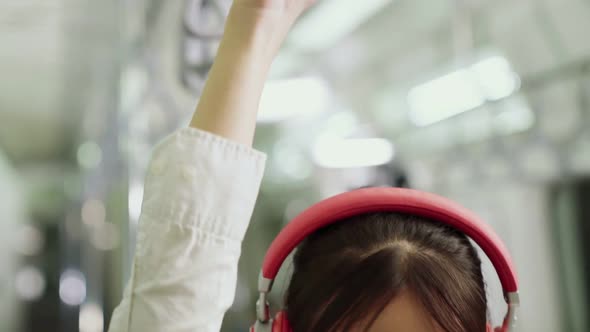 Young Woman Using Mobile Phone on Public Train