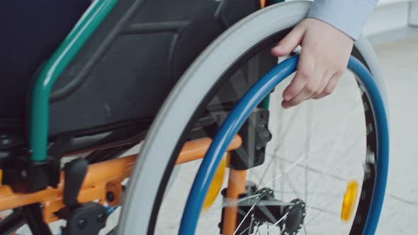 Boy Riding Wheelchair in Closeup