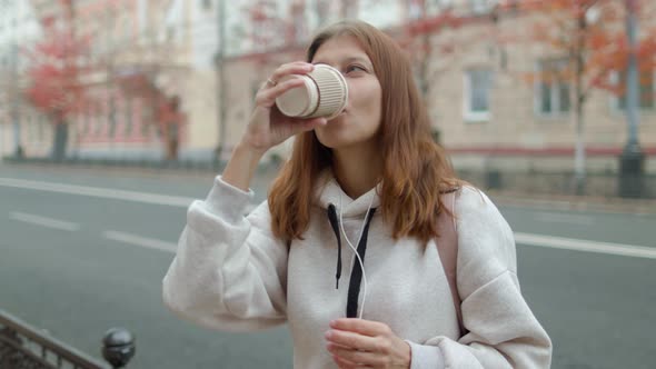 Beautiful Woman In The City Drinks Coffee