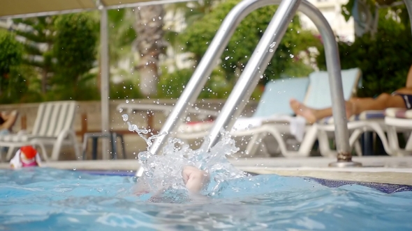 Girl Learns To Dive Into the Water By Clamping Her Nose in the Pool at the Resort