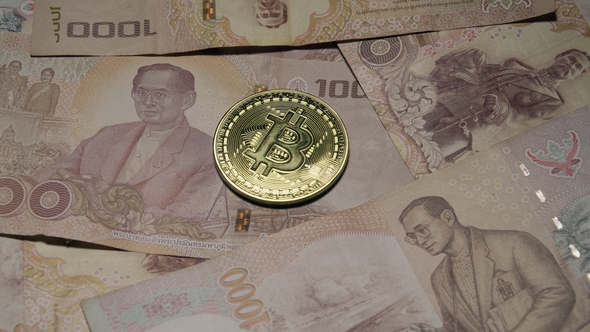 Bitcoin on Thai Baht Banknotes Rotating on Turntable. National Currency of Thailand. Digital