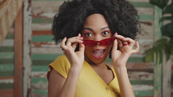 Cool Curly African American Lady Model Flirting to Camera Taking Off Sunglasses and Smiling Slow