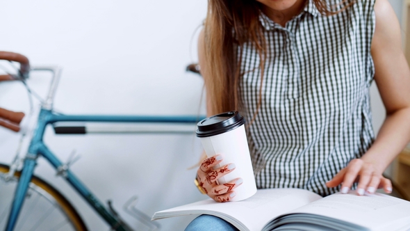 of a Woman Sitting and Writing in Her Journal in Busy Coffee Shop