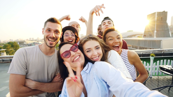 Point of View Shot of Happy Friends Taking Selfe on Roof at Summer Party Laughing, Posing and