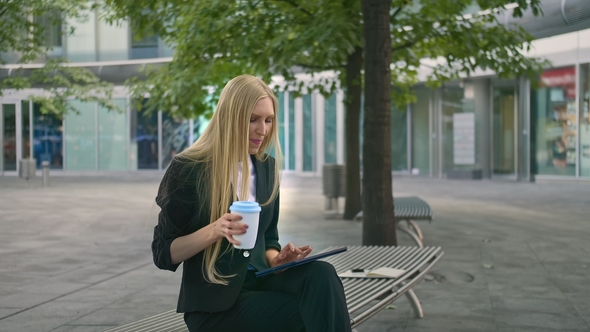 Young Business Woman Using Tablet and Drinking Coffee Modern Executive Woman in Suit