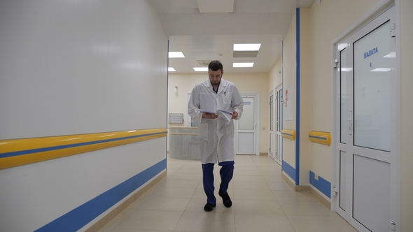 The Doctor Walks Down the Corridor and Reads the Patient's Medical History