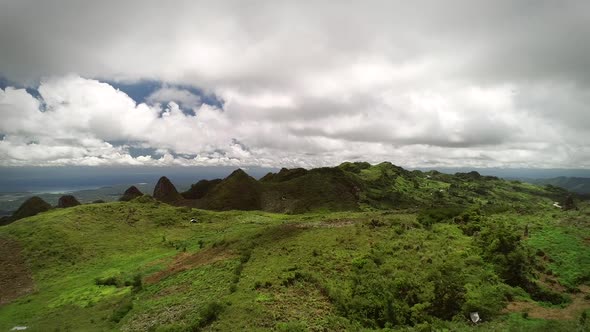 Aerial view of peak Chocolate hills and cloudy sky in Badian, Philippines.