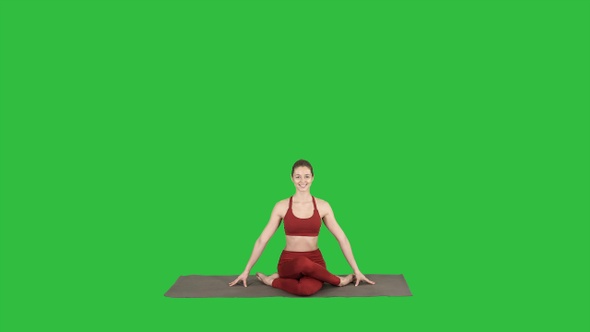 Young attractive woman practicing yoga sitting in Gomukasana