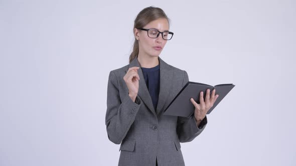 Young Beautiful Businesswoman Talking While Reading Book