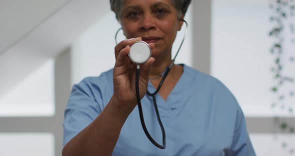 Portrait of senior african american female doctor holding stethoscope looking at camera
