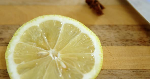 Various spices with lemon slice and knife on chopping board 4k