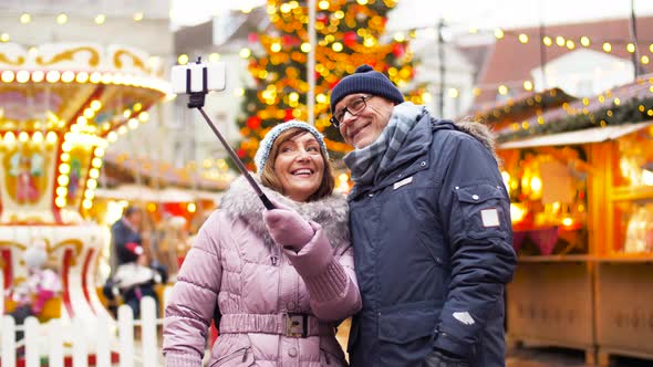 Senior Couple Taking Selfie at Christmas Market