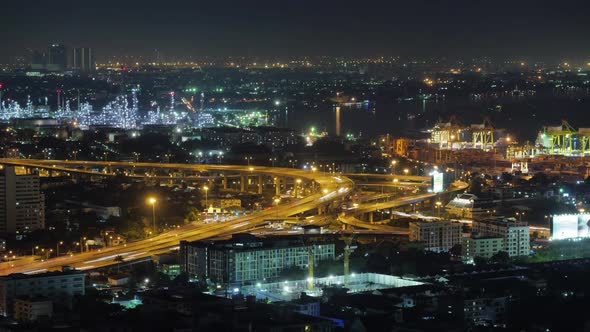 view of Bangkok city, Thailand, showing traffic on motor way, oil refinery and shipping port