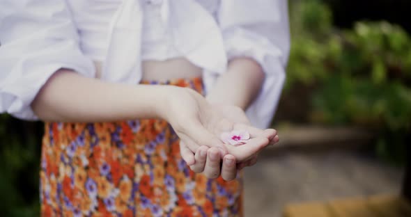 Female Pal Hands Holding Pink Flower