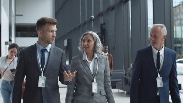 Three Business Partners Talking in Airport