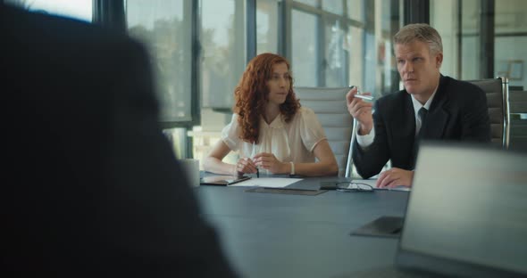 Group of business people meeting in an office to discuss a business project. Medium shot,slow motion