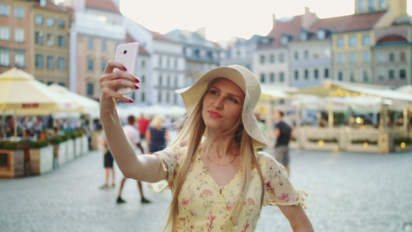 Woman Taking Selfie on Square. Attractive Woman Posing for Selfie and Standing on City Square.