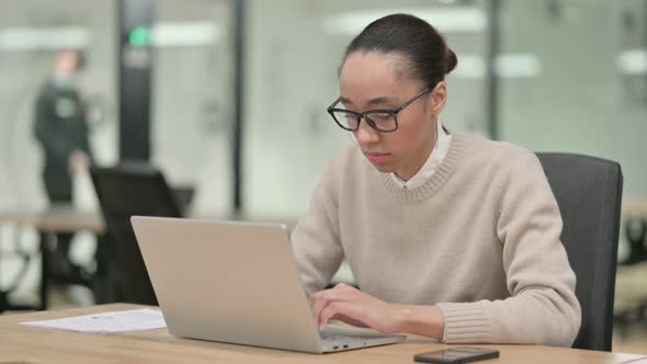 Creative African Woman with Laptop Having Headache