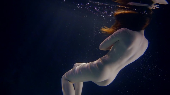 Charming Woman Is Floating Naked Underwater