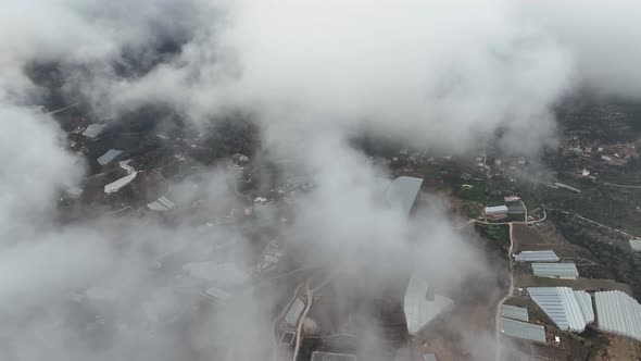 Over the city in the clouds aerial view 4 K