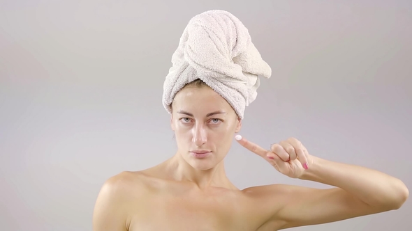 Portrait of Young Woman with Perfect Skin Applying a Day/night Cream on Her Previously Cleansed Face