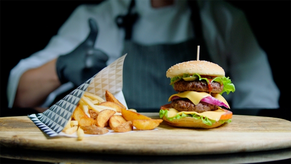 Chef Is Showing Thumb Out of Focus and Set of Tasty Burger, French Fries