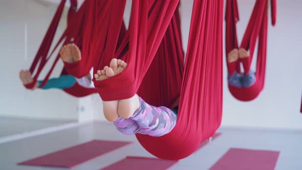 Ladies Lie with Bare Feet in Long Aerial Fly Yoga Hammocks