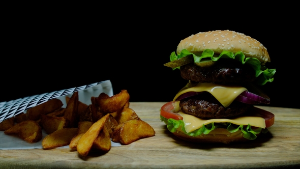 Burger with Double Cheese and French Fries Black Background