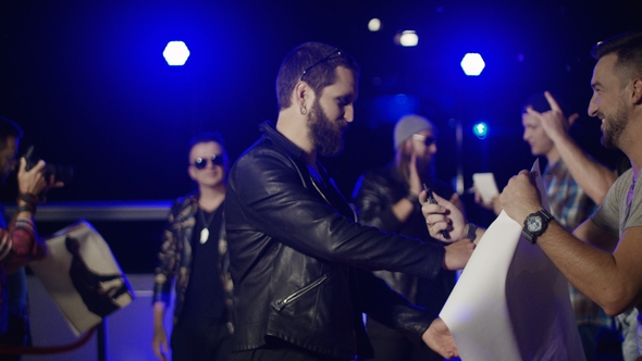 Musicians Giving Autographs To Fans