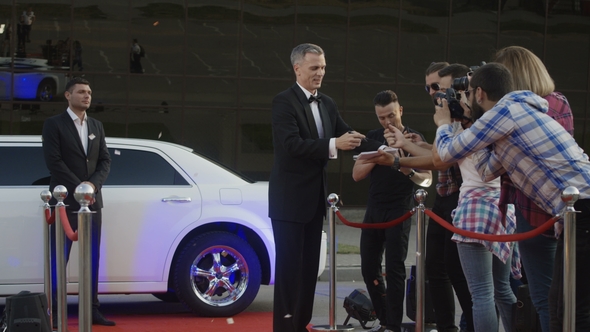 Adult Celebrity Giving Autographs on Red Carpet
