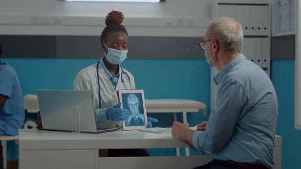 Young Medic Showing Modern Tablet with x Ray Scan