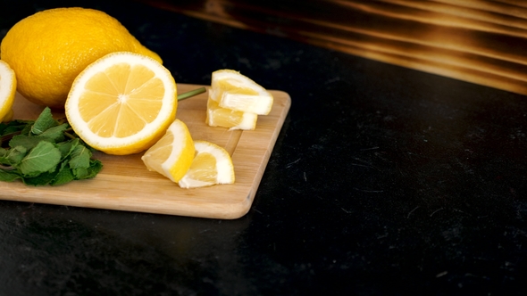 Lemons on a Wooden Board and Two Glasses with Homemade Lemonade