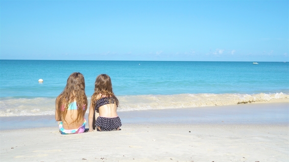 Adorable Little Sisters at Beach During Summer Vacation