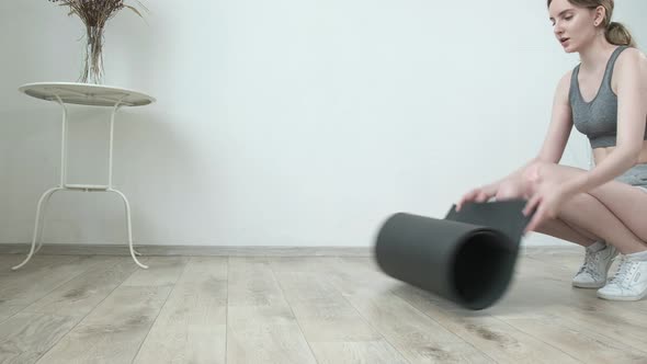 Female Preparing for Pilates Lesson Meditation at Home