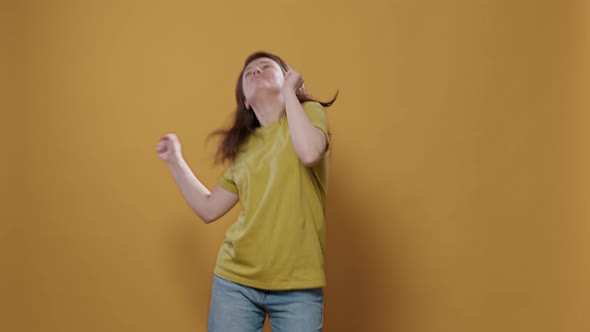 Portrait of Smiling Happy Young Person Dancing Alone in Studio Feeling Confident Moving to the Rithm