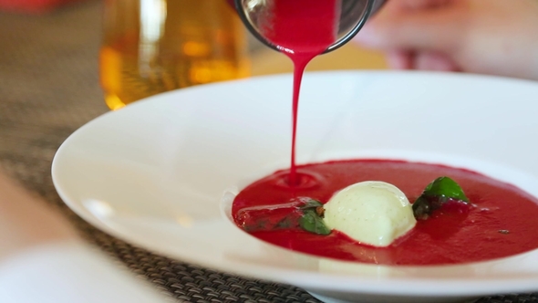 Pouring the Soup Puree From Beet Into a Bowl