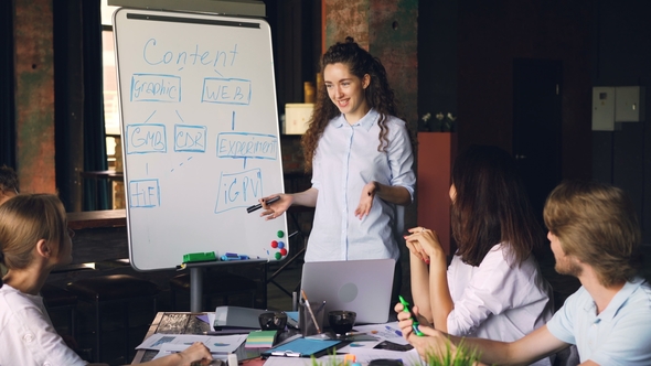 Company Employees Are Applauding Young Woman After Successful Presentation