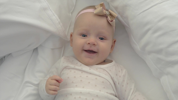 Top View of an Adorable Baby Girl with a Golden Bow