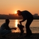 of a Young Family Walking By the River at Sunset - VideoHive Item for Sale