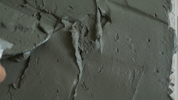 Professional Constructor Applying Cement on Floor and Laying Ceramic Tiles alt