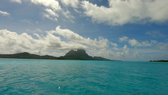 Sailing with a dingi over the ocean in front of Bora Bora in French Polynesia